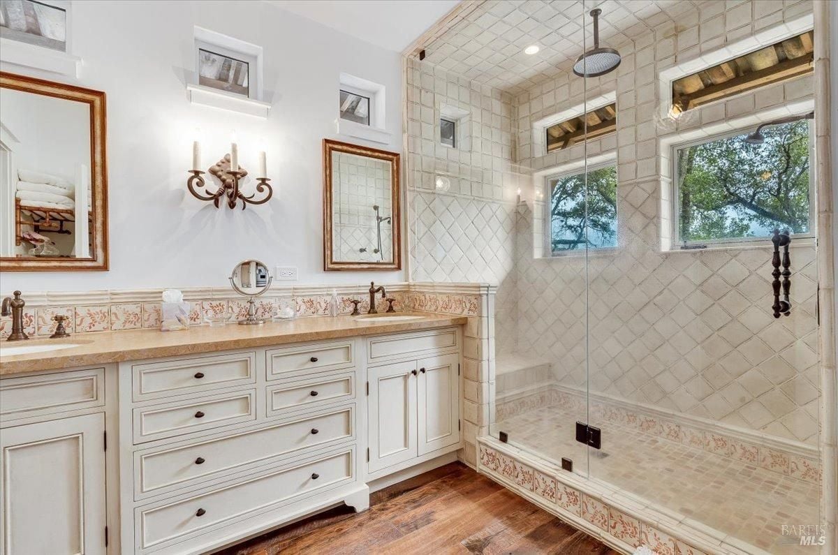 Bathroom with sinks and walk-in shower.