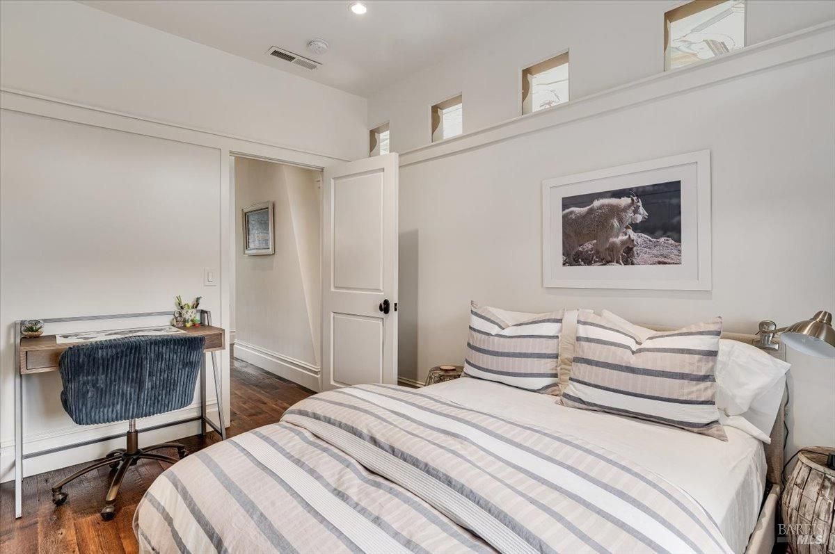 Bedroom with a large bed and a desk.