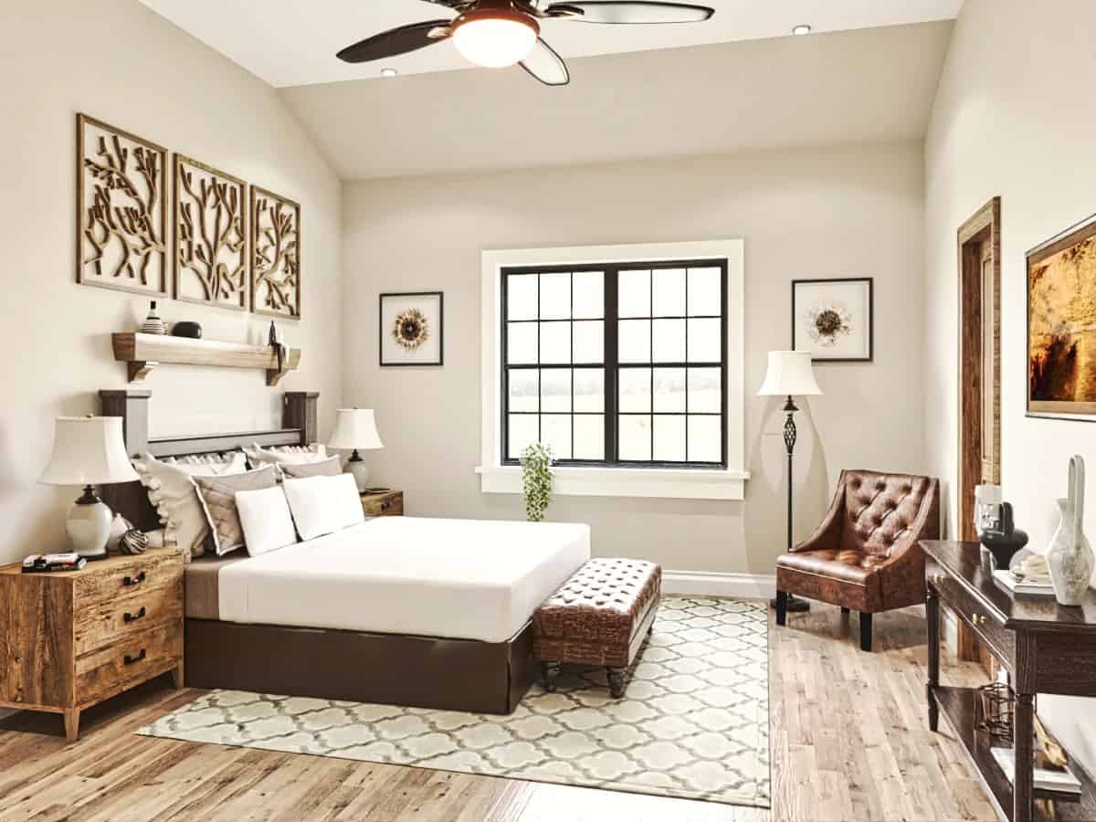 Primary bedroom with a dark wood bed, a leather tufted bench, and a matching armchair over the hardwood flooring.
