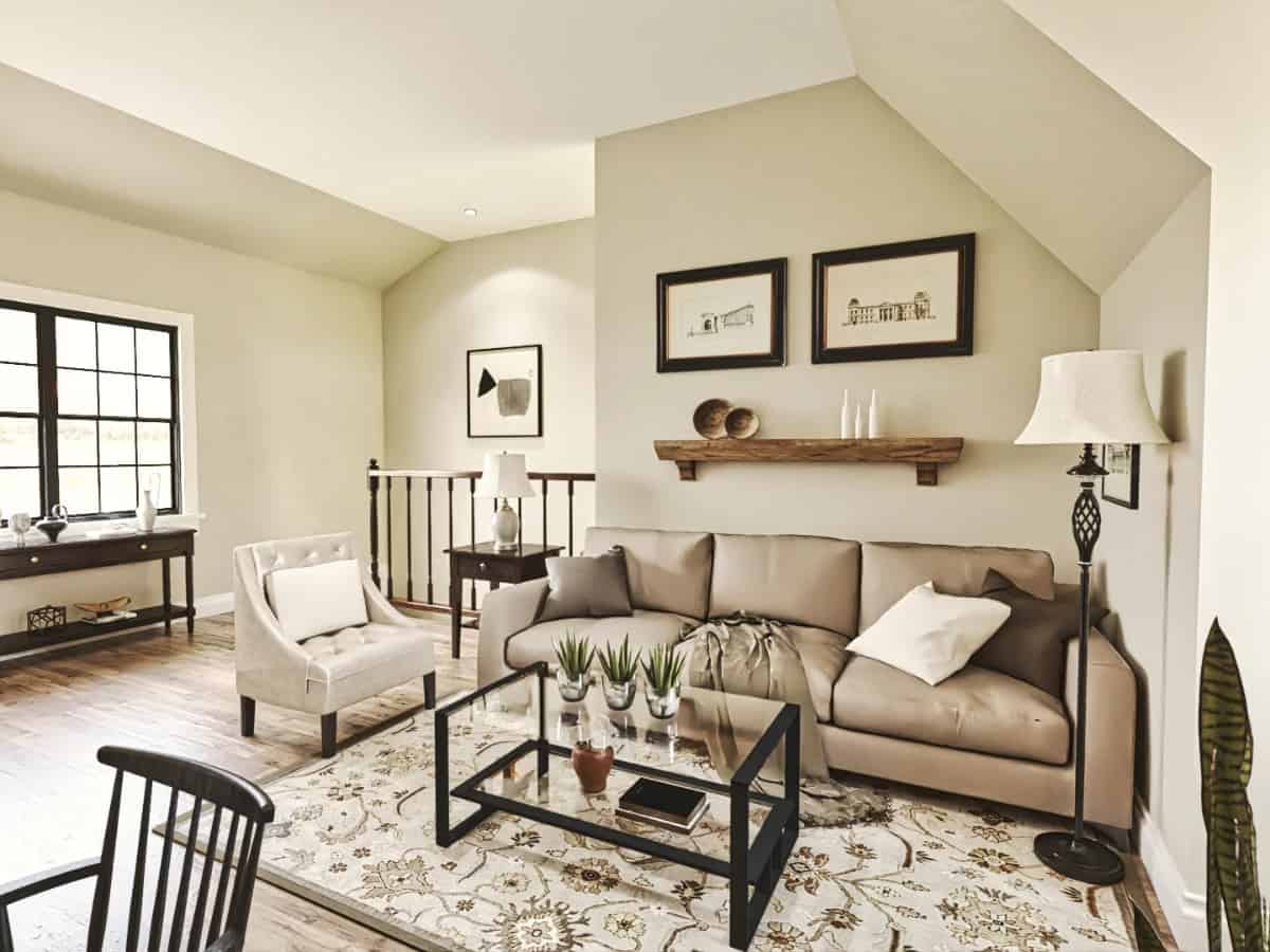 Living space with a leather seats and a glass-top coffee table over a floral area rug.