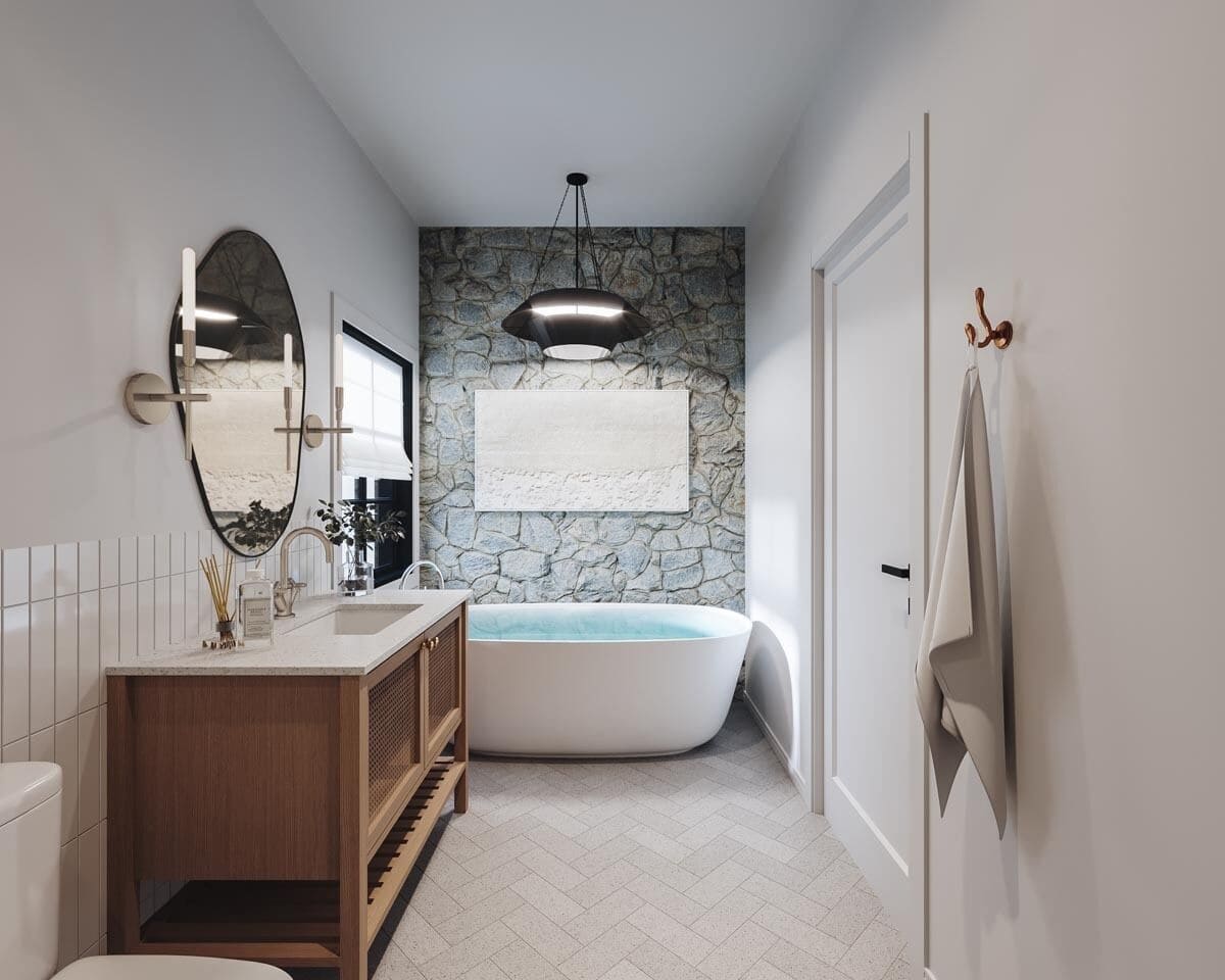 Bathroom with a wooden vanity and a soaking tub against the stone accent wall.