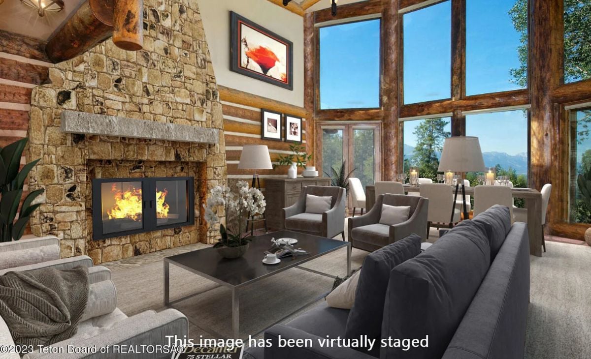 Living room with couches, large glass windows, and a fireplace.