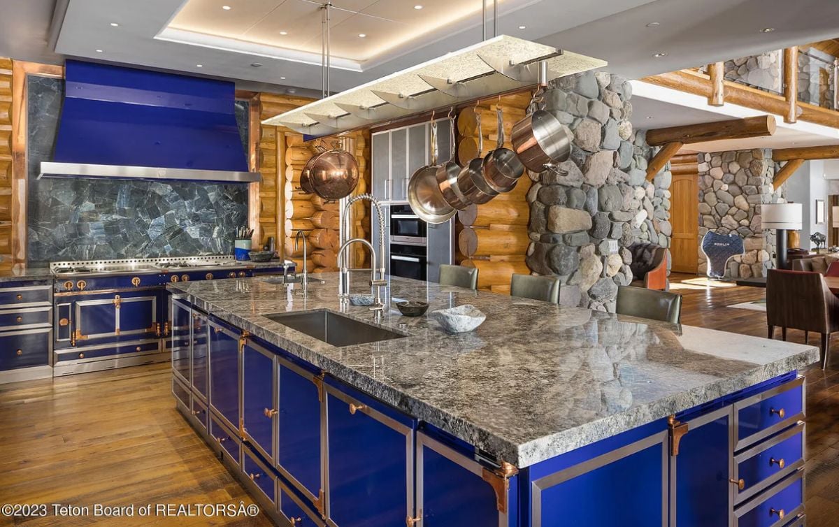 Kitchen with leather & glass cabinetry and a rare dumortierite backsplash.