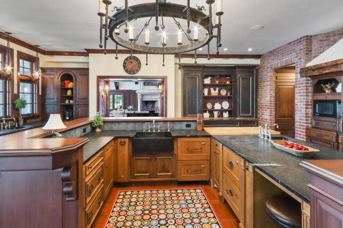Kitchen with custom cabinetry, a large island and a chandelier.