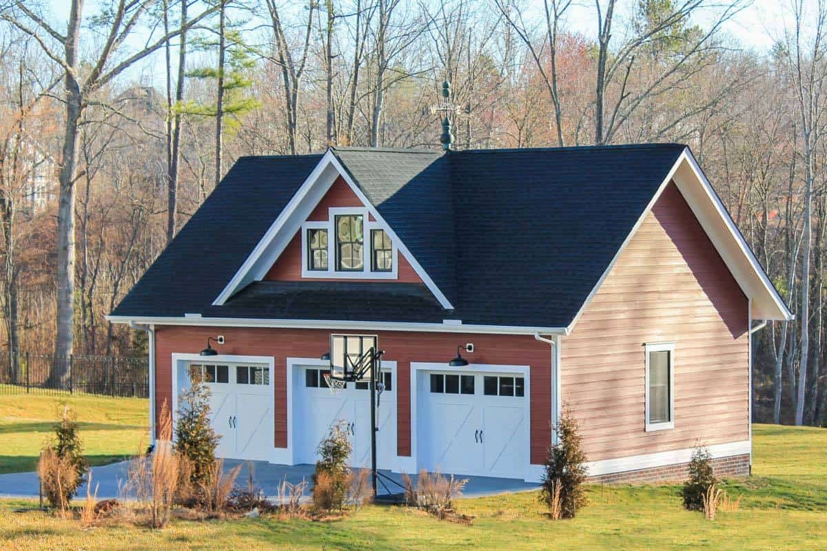 Detached garage with clapboard siding and a central gable.