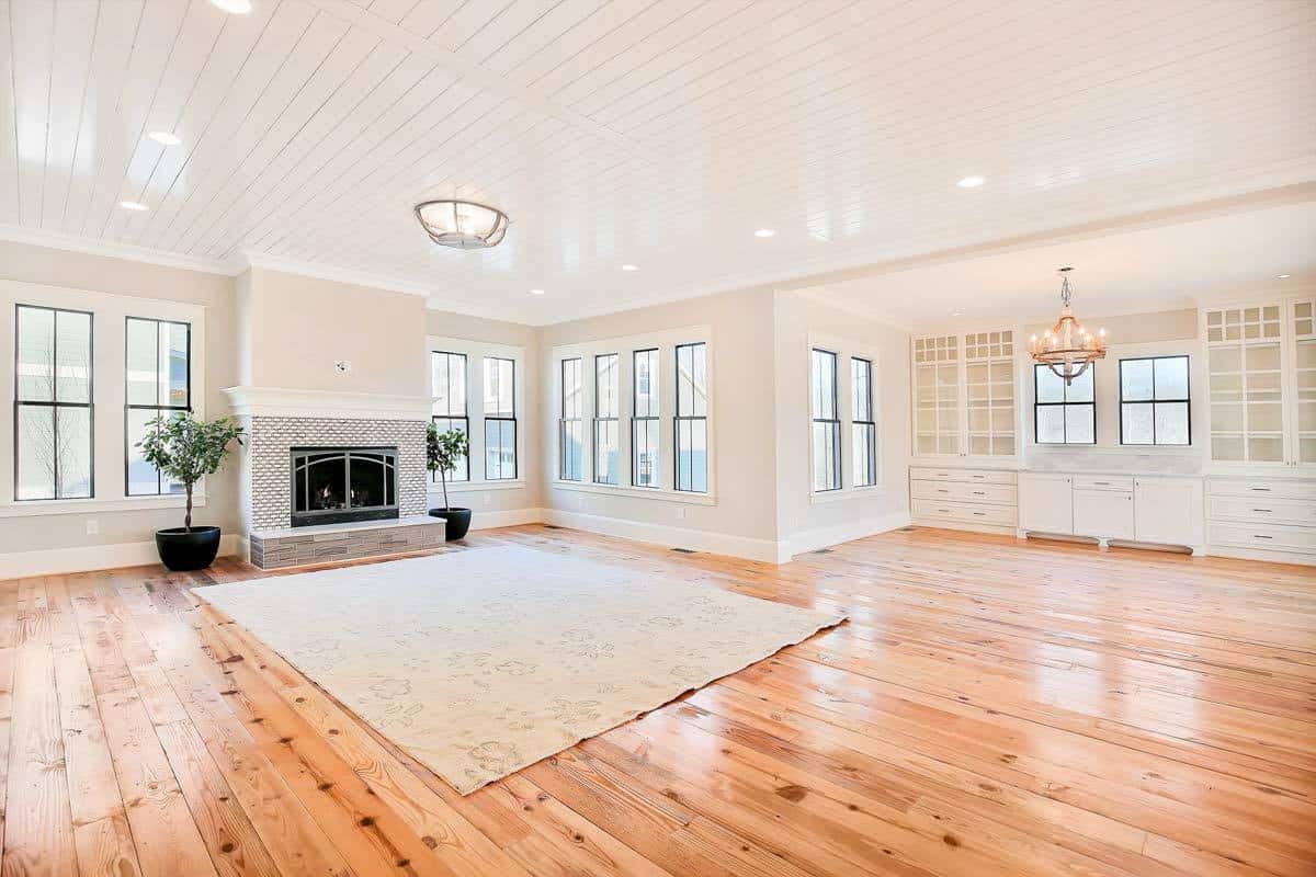 Great room and dining room with a fireplace and built-in cabinets.
