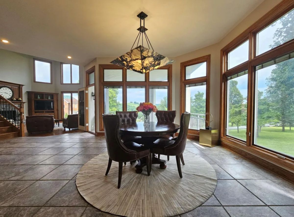 Spacious dining room with large glass windows and tile flooring.
