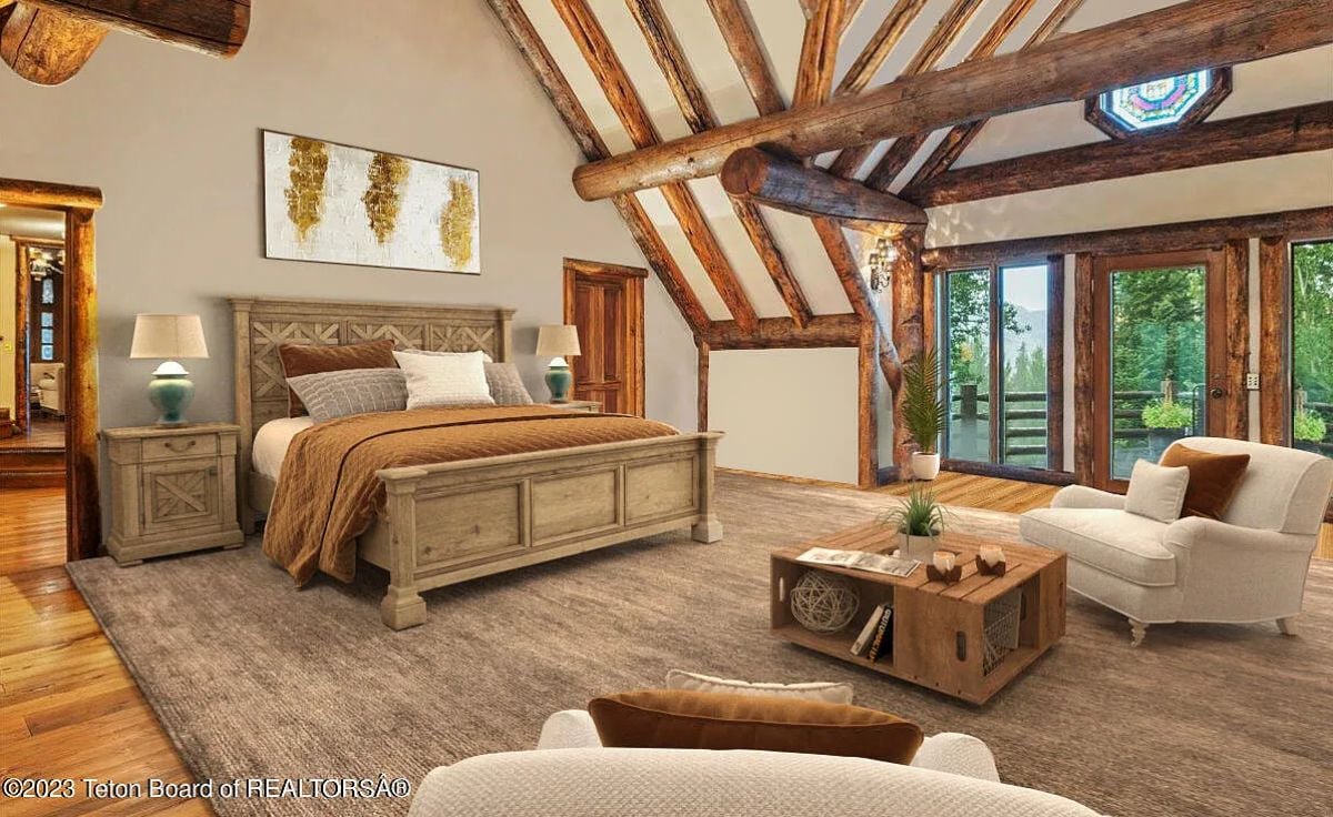 Bedroom with wooden floors, vaulted ceiling, a large rug, and glass windows.