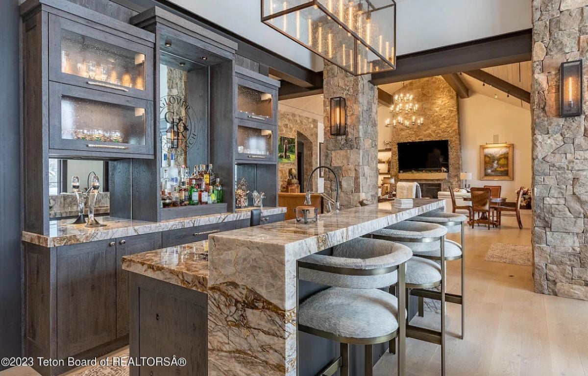 Bar with custom cabinetry and custom lighting.