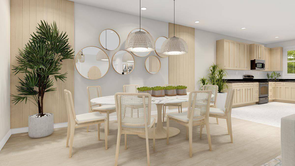 Dining area with an oval dining set topped with a couple of dome pendants.