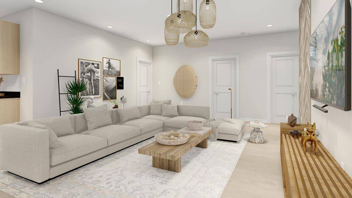 Family room with an L-shaped sectional, wooden tables, and a wall-mounted TV.
