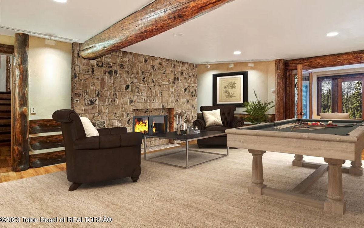 Billiards room with couches and a fireplace.