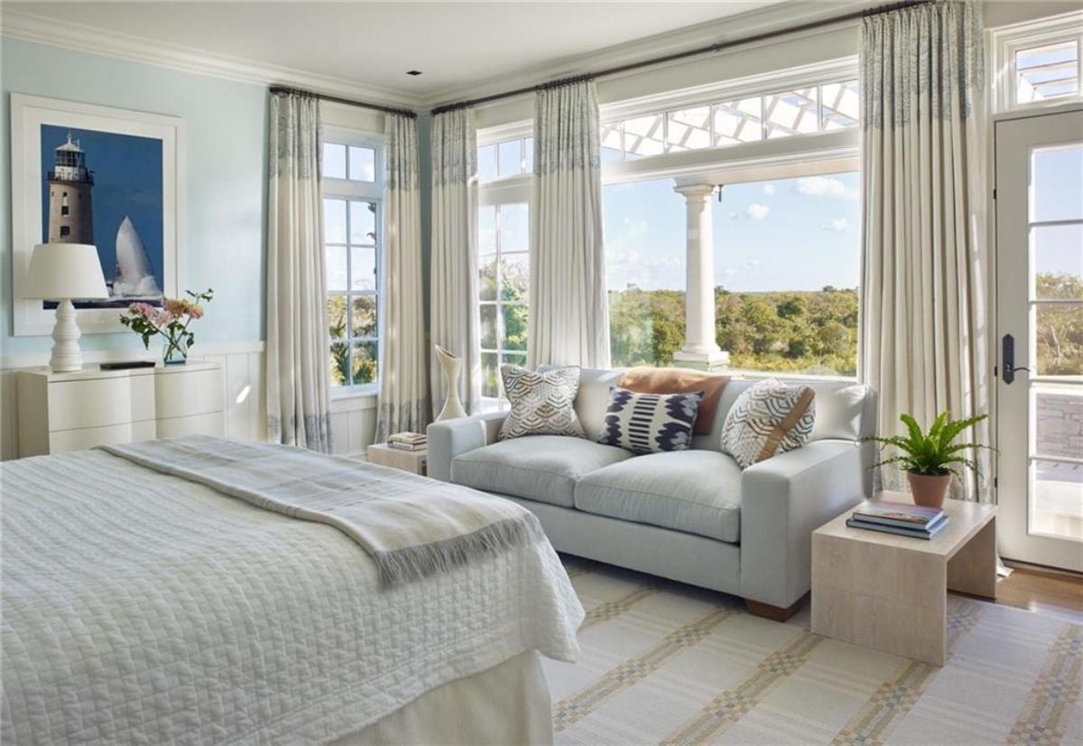 Bedroom with couch near the window.