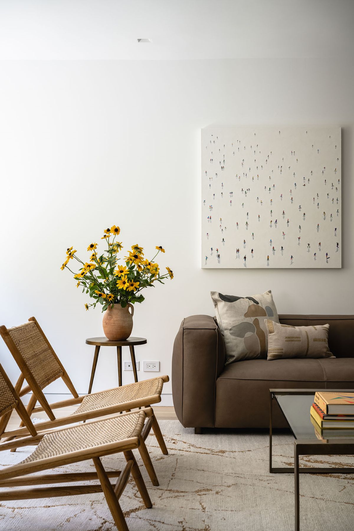 A modern living room with chairs, couch and a center table