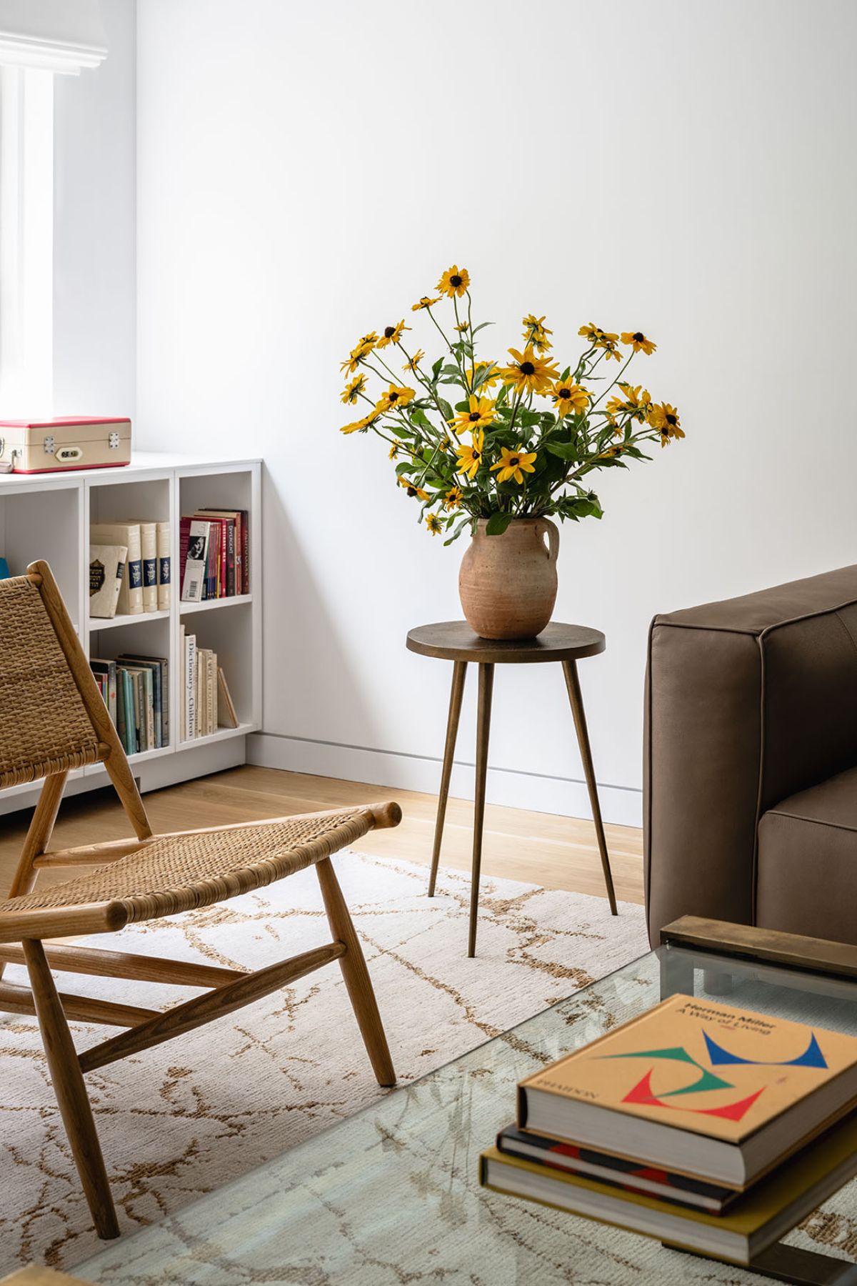 A modern living room with chairs, couch and a center table