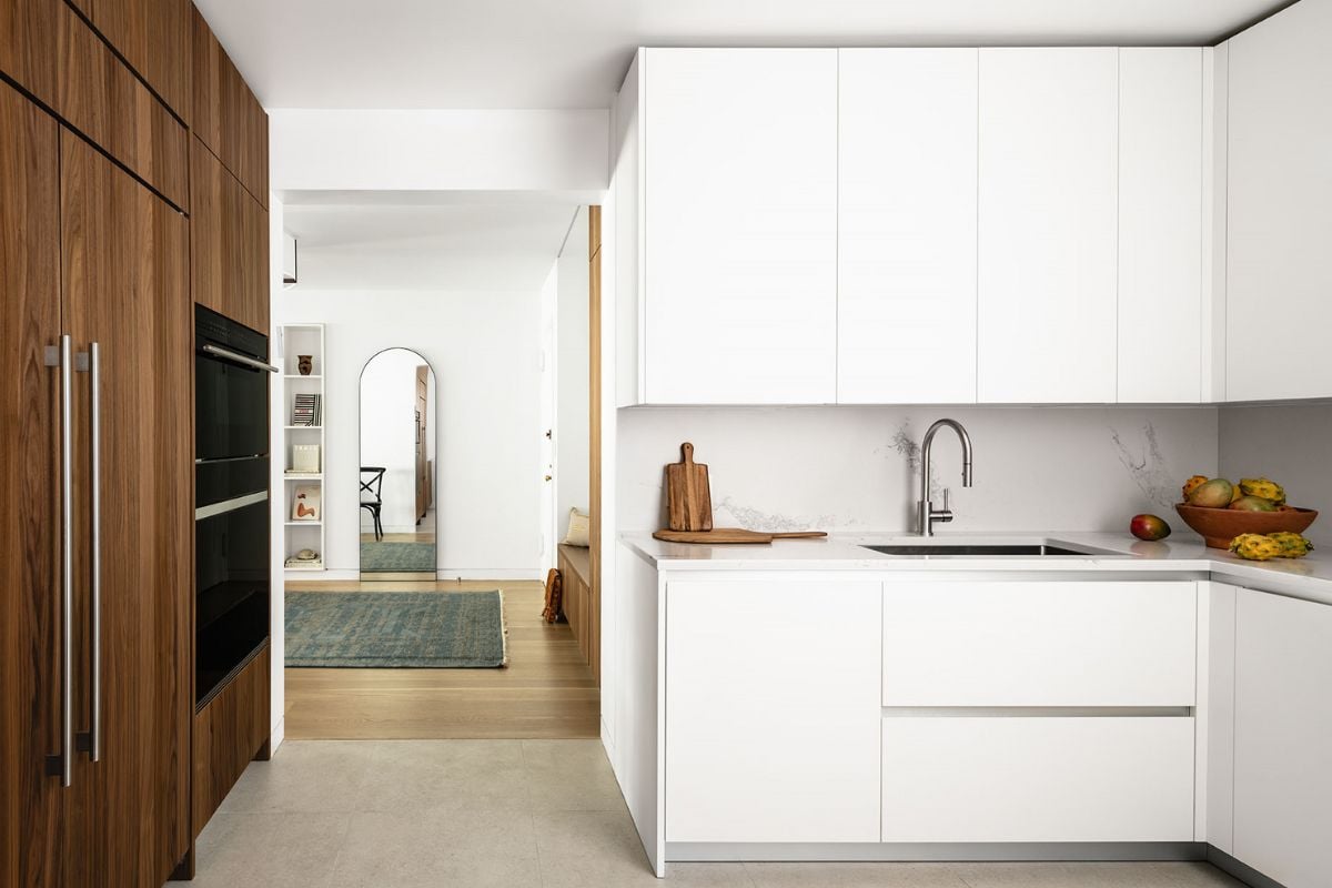A kitchen with white cabinets and a sink