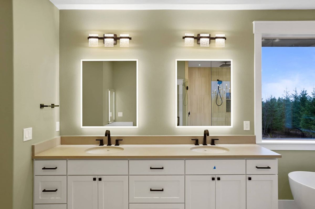 Bathroom with a sink, mirrors and custom lights.