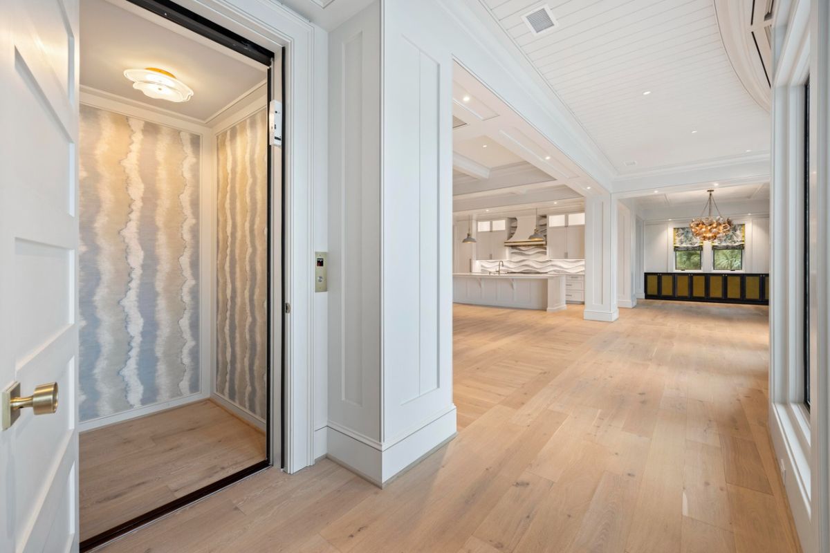 Elevator with custom light and wood floors.