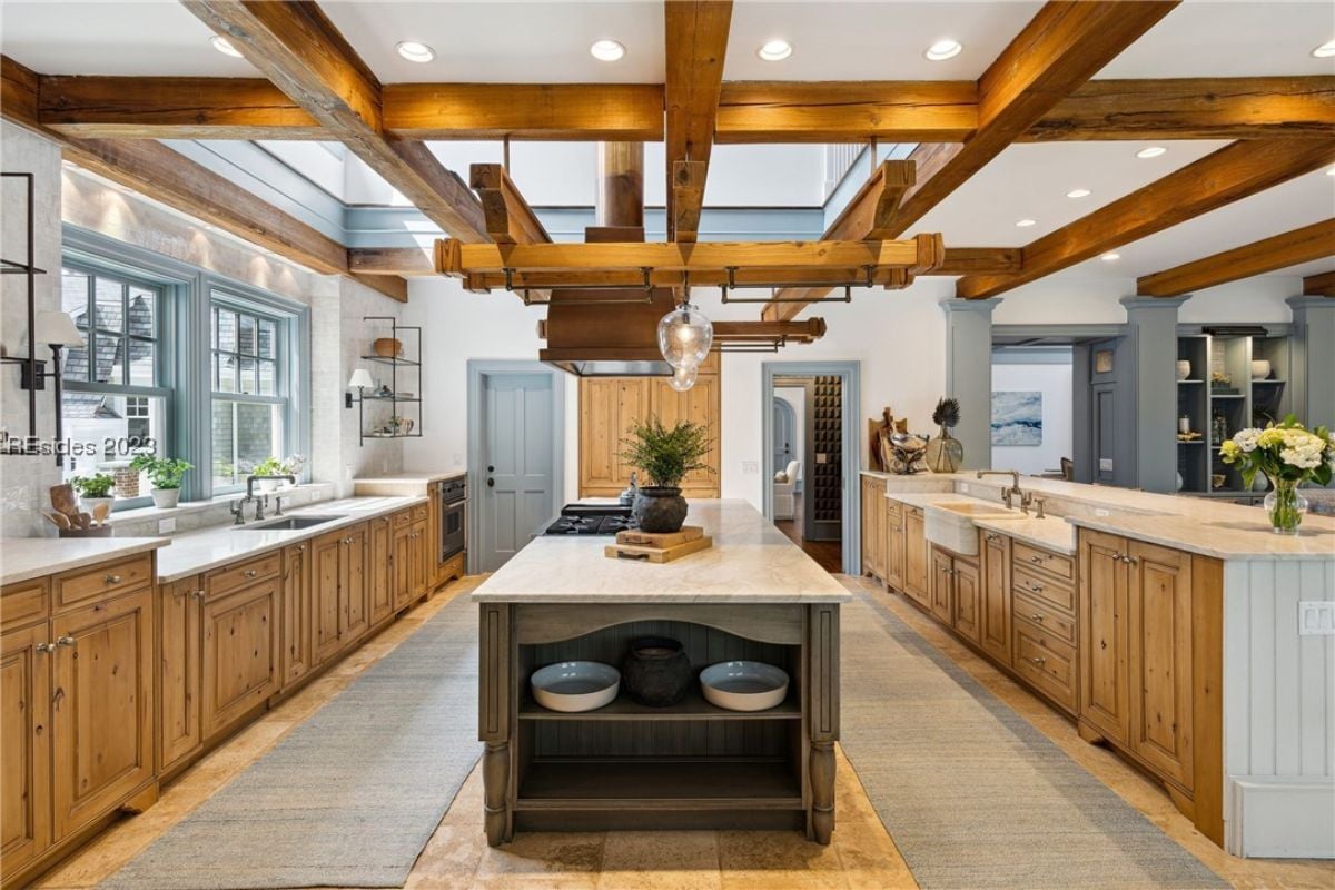 Kitchen with vaulted ceilings, a large island, custom cabinets and custom lights.