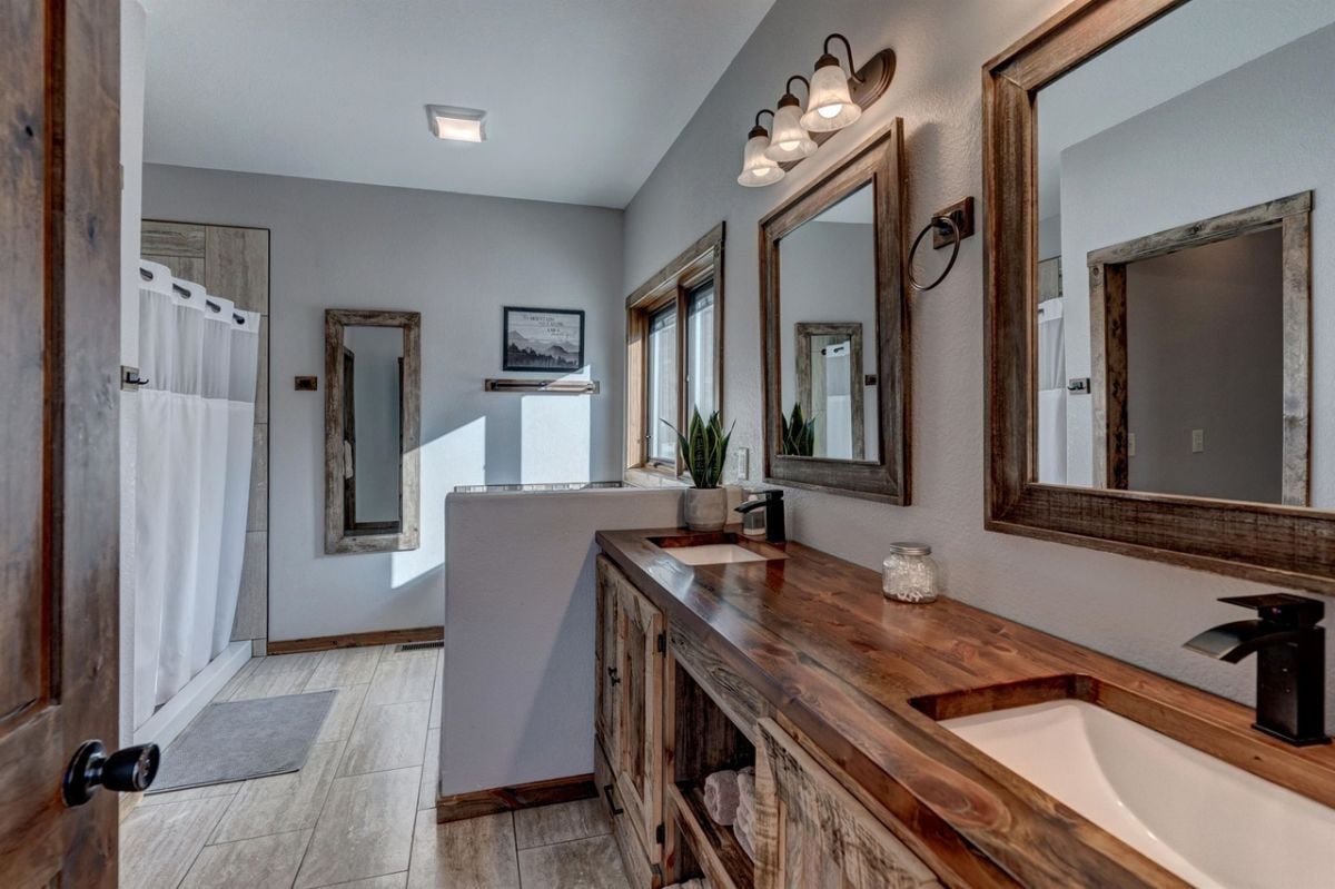 Bathroom with wooden vanity and wood flooring.