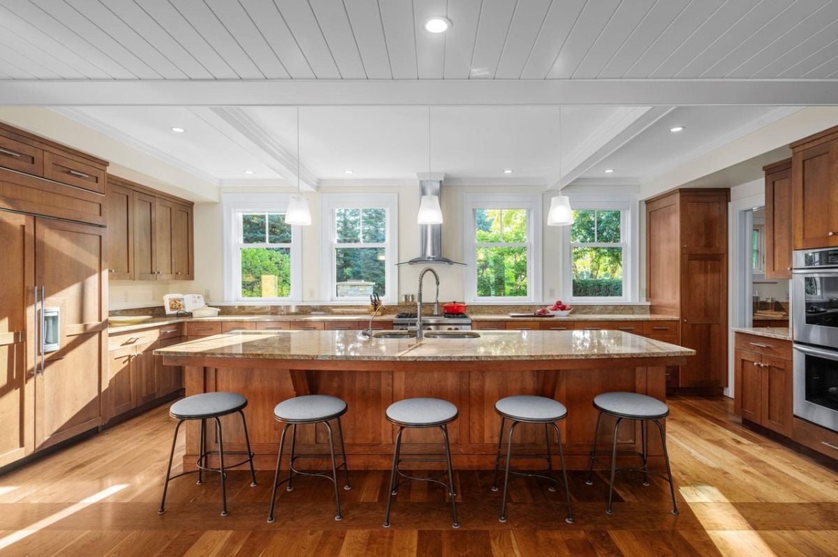 Kitchen with a large center island, custom lights, custom cabinets and top-of-the-line appliances.