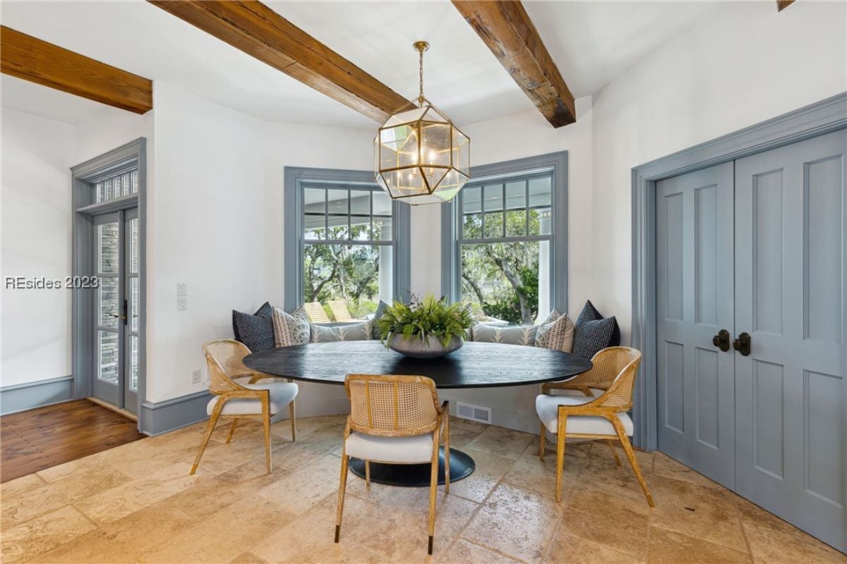 Breakfast nook with a round table and chairs.