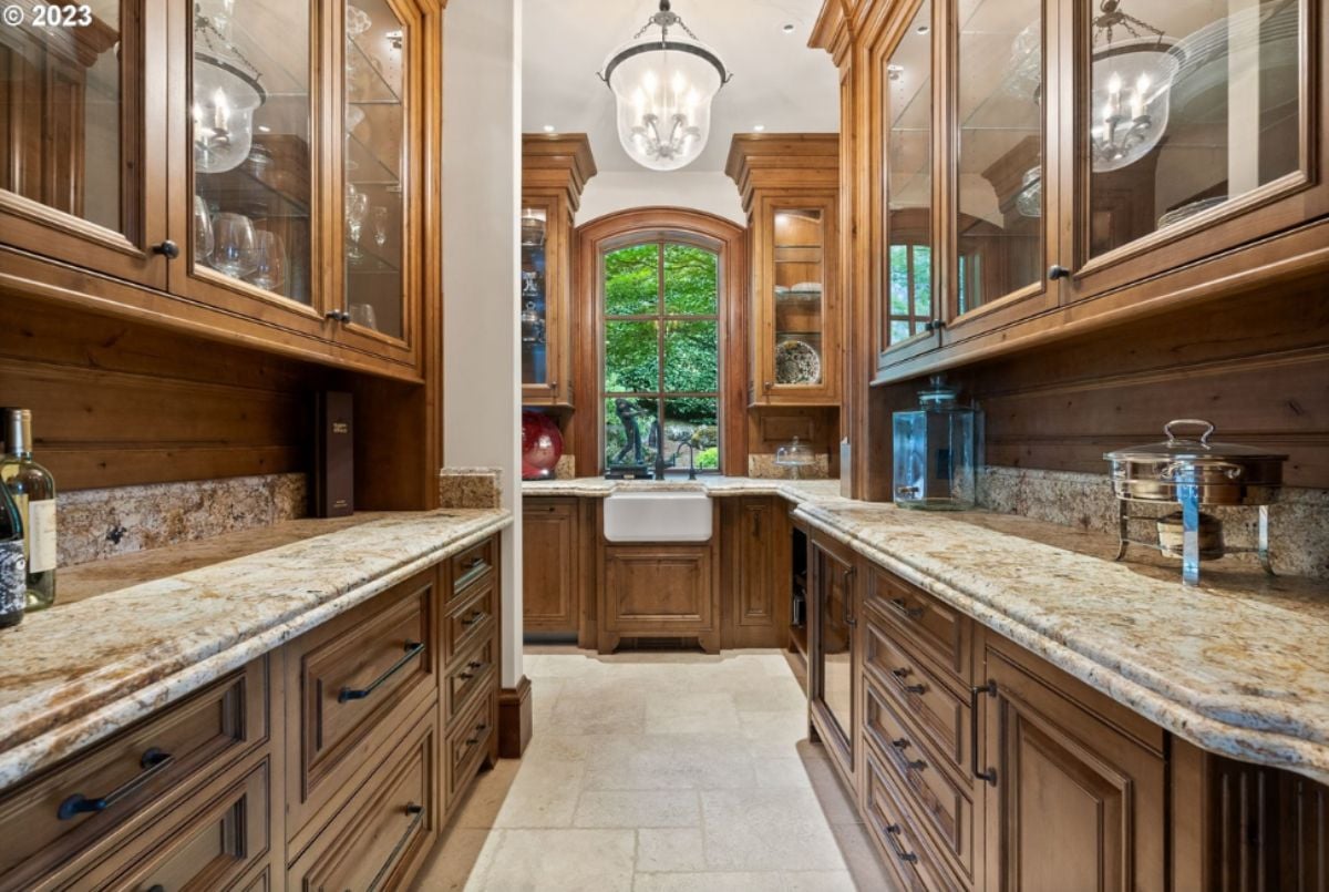 Pantry with custom cabinets and custom light.