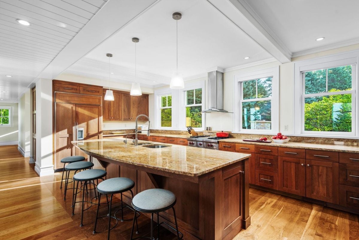 Kitchen with a large center island, custom lights, custom cabinets and top-of-the-line appliances.