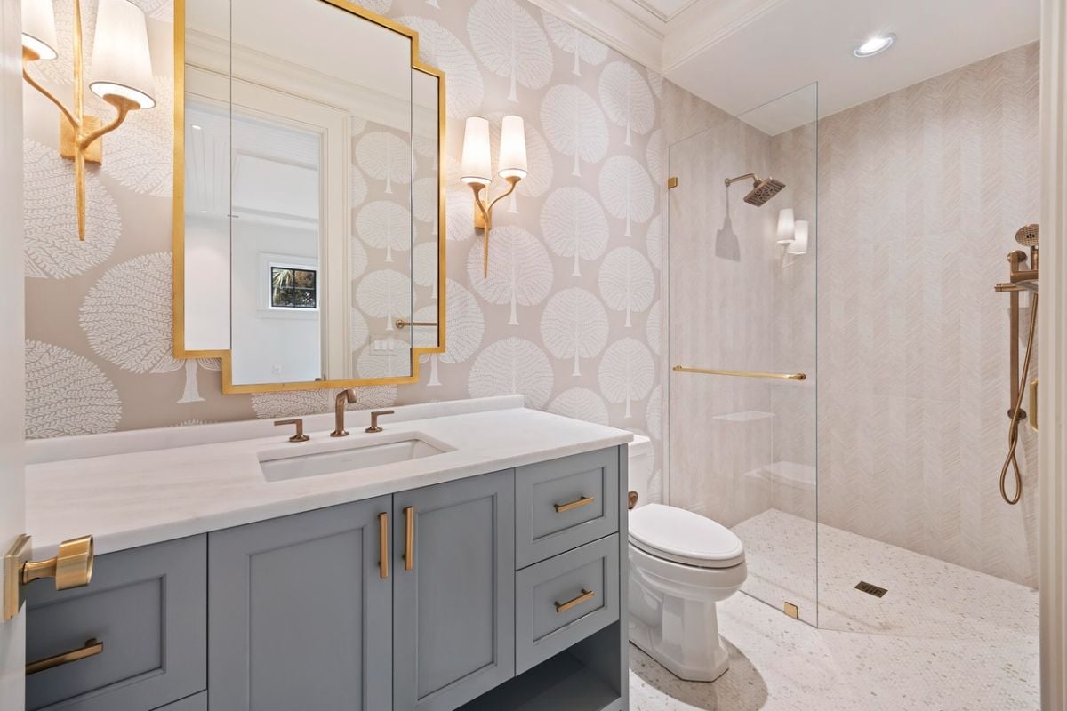 Bathroom with a sink, walk-in shower and a toilet.