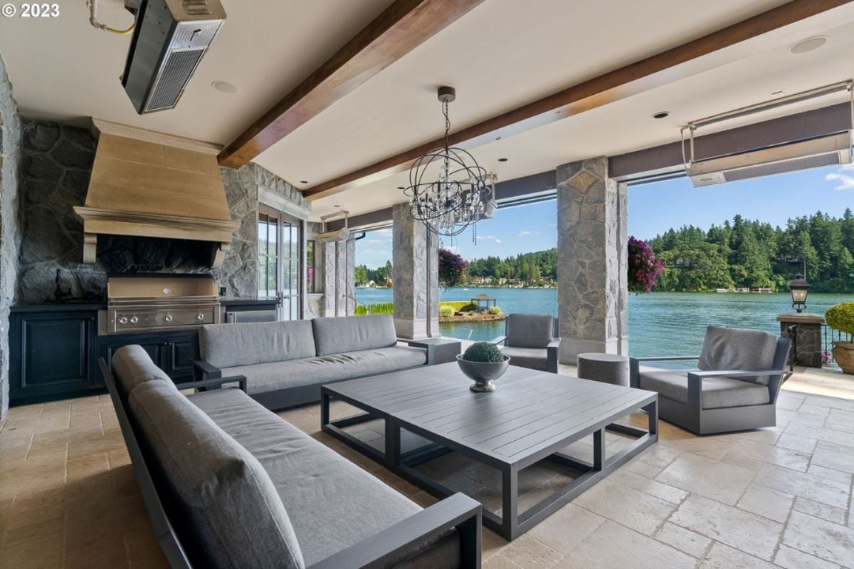 Living room with couches, chandelier and tile flooring.