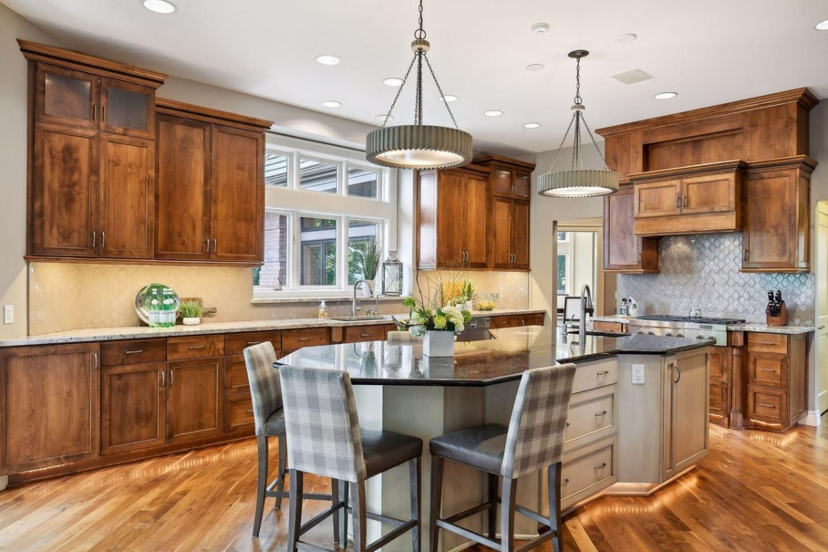 Kitchen with a breakfast area, custom lights and custom cabinets.