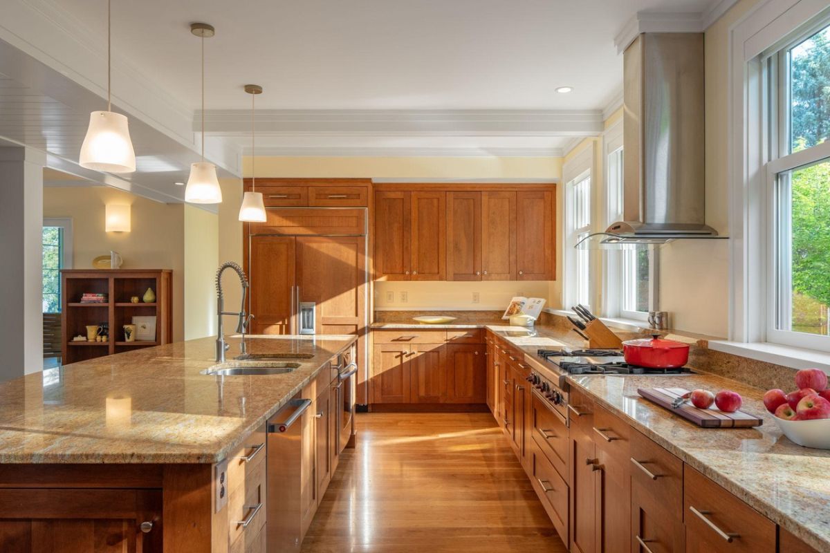 Kitchen with a large center island, custom lights, custom cabinets and top-of-the-line appliances.
