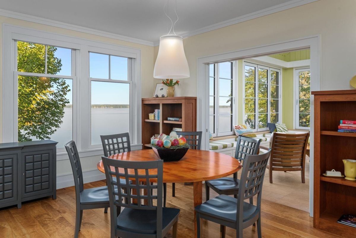 Breakfast nook with a round wooden table and chairs.