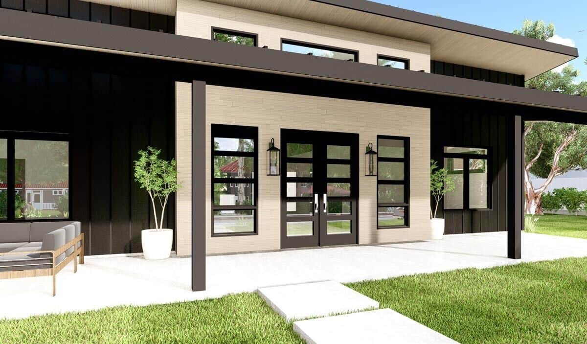 Covered front porch with wooden pillars and a French entry door flanked by windows.