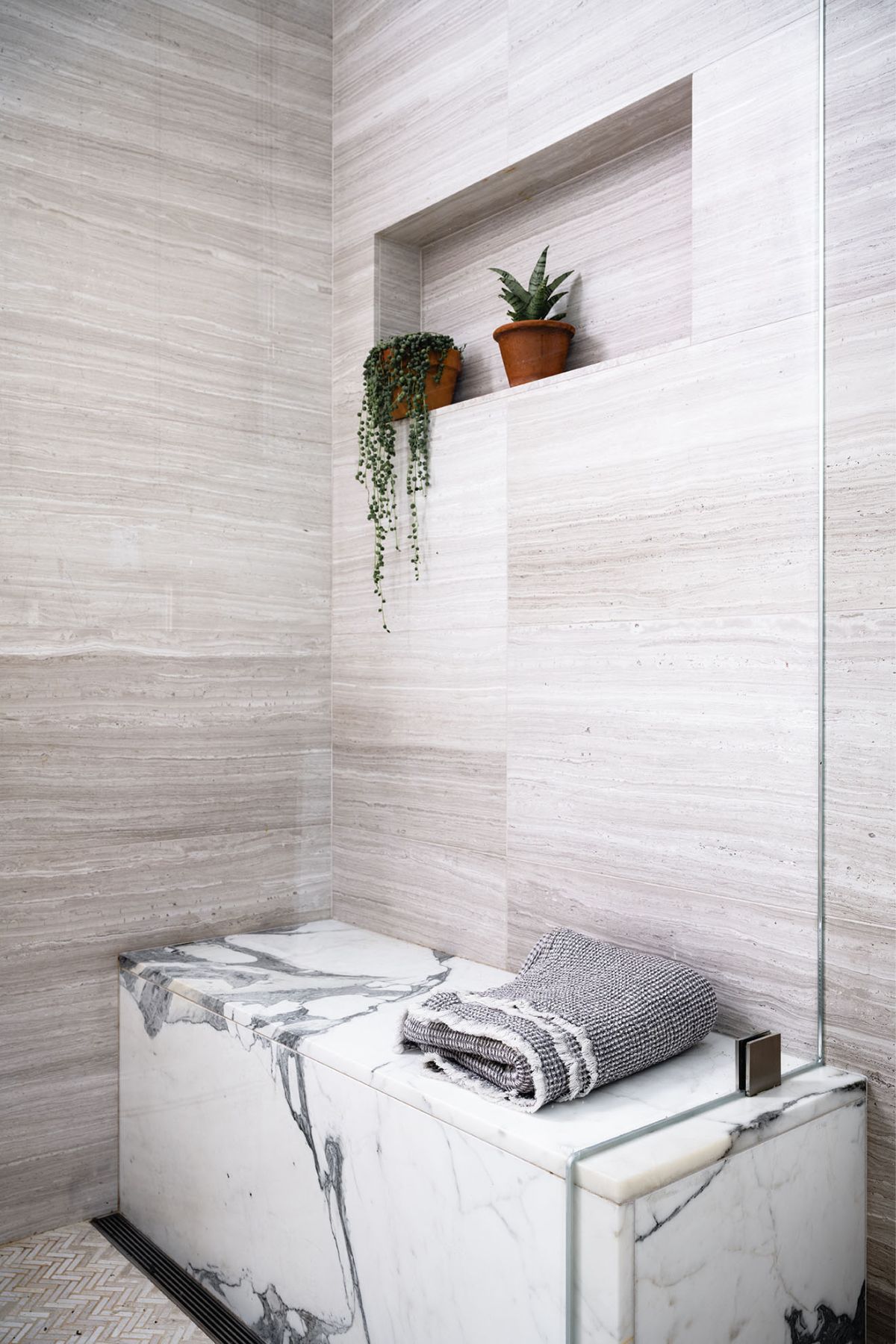 A bathroom features a marble bench