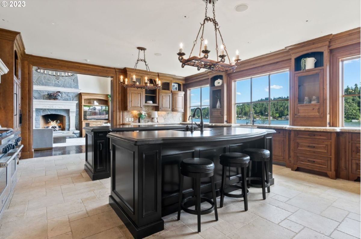 Kitchen with two large islands and two chandeliers.