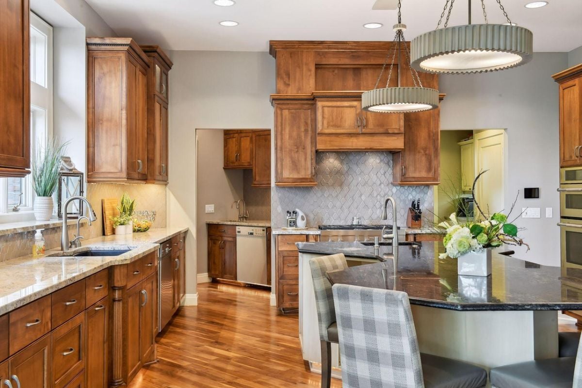 Kitchen with a breakfast area, custom lights, and custom cabinets.