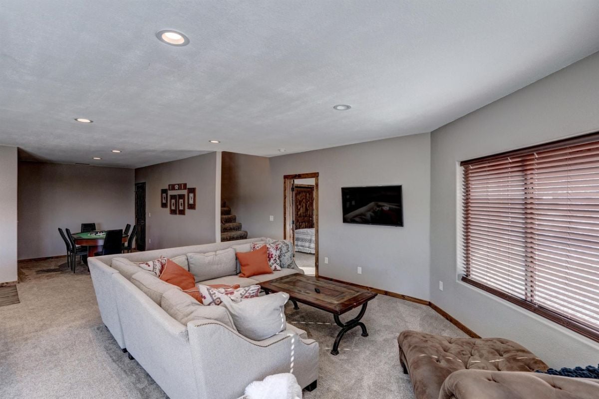 Recreation room with couches and carpet flooring.
