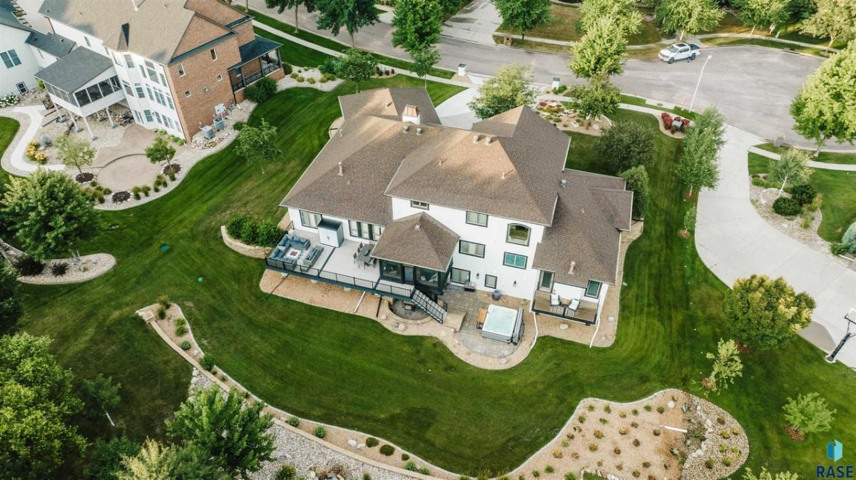 Aerial rear view of the house with a large green lawn.