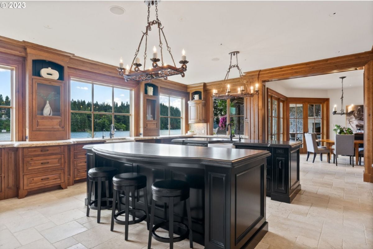 Kitchen with two large islands and two chandeliers.
