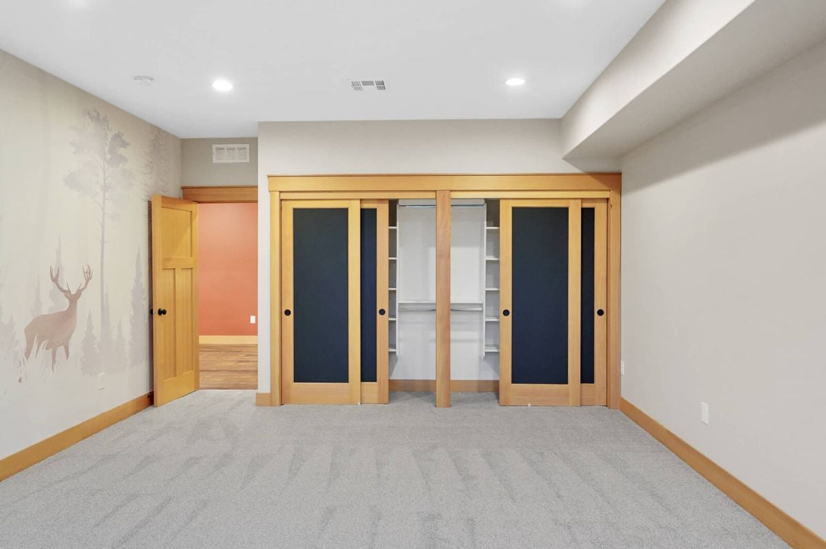Bedroom with custom lights and a closet.