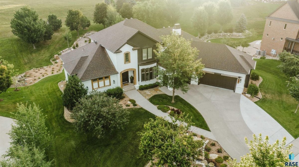 Aerial view of the house with trees in the background.
