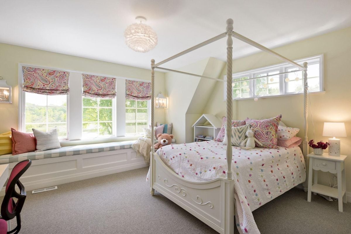 Bedroom with a large bed, carpet flooring and custom lights.