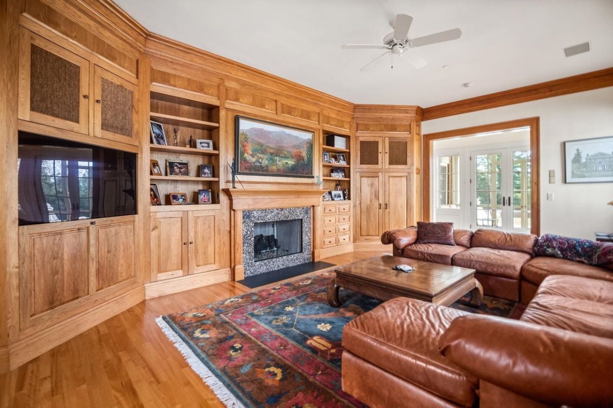 Media room with couches, a TV and a fireplace.