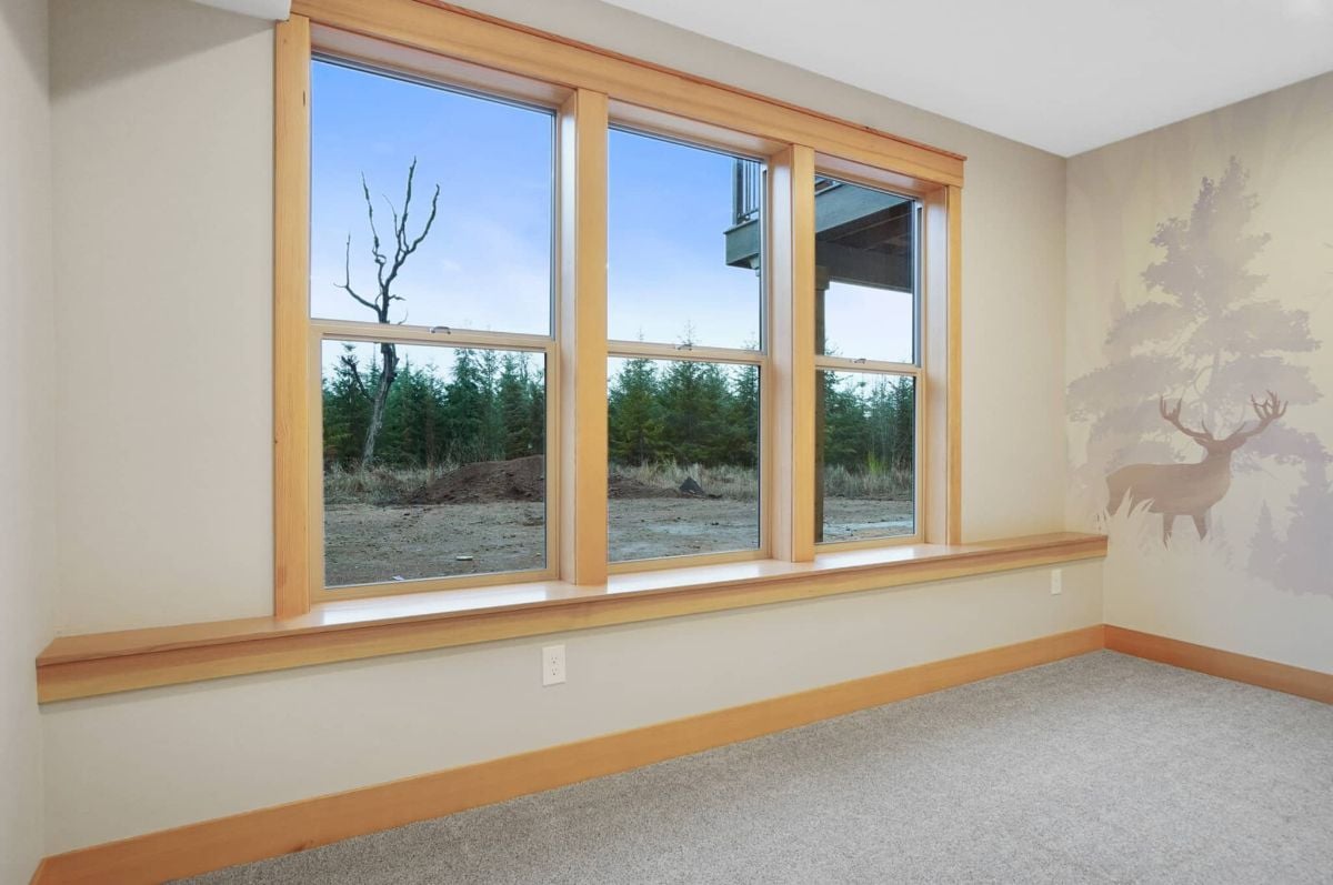 Bedroom with glass windows and carpet flooring.