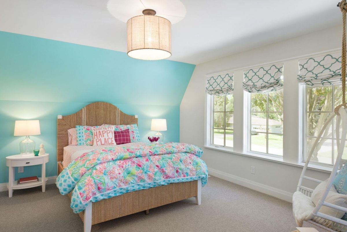 Bedroom with a large bed, carpet flooring and custom lights.