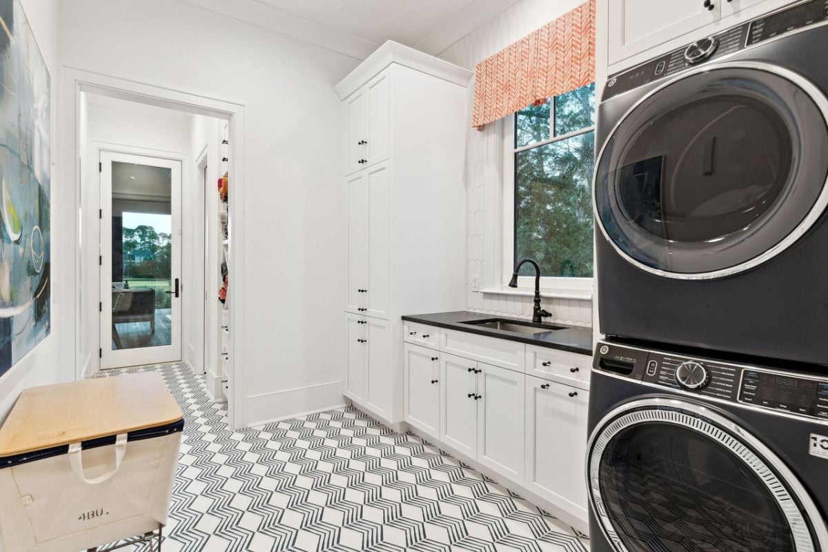 Laundry room with a sink, washer and dryer.