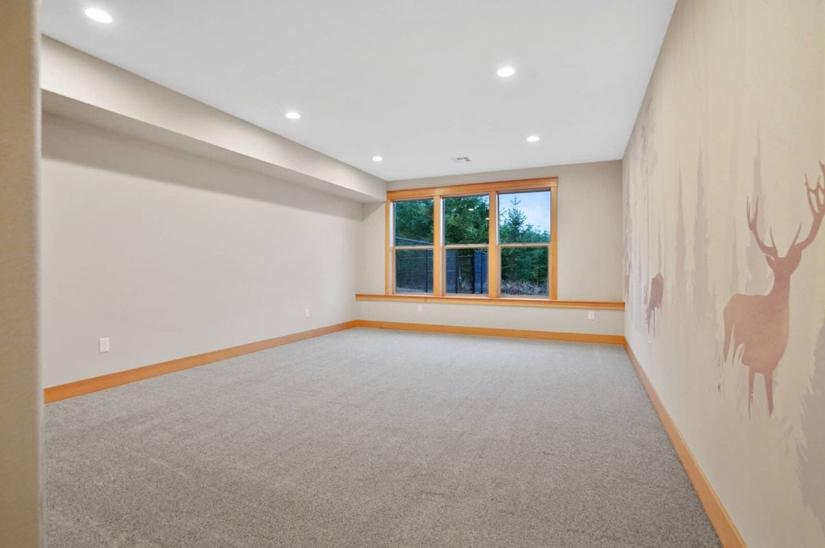 Bedroom with custom lights, glass windows and carpet flooring.