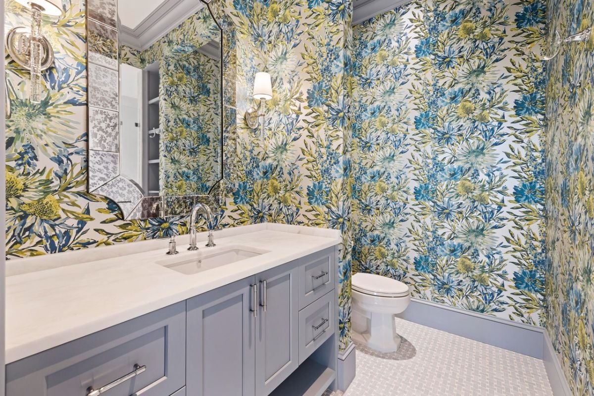 Bathroom with a sink, a large mirror, toilet and custom lights.
