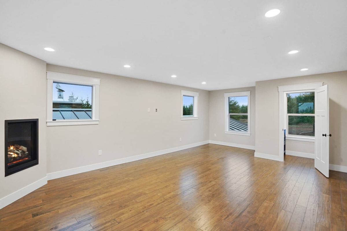 Bedroom with custom lights, glass windows and a fireplace.